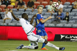 The Jets' Morten Nordstand sneaks past Victory's Jason Geria in their nil-all game at McDonald Jones Stadium, Newcastle on Monday the 13th of February, 2017.